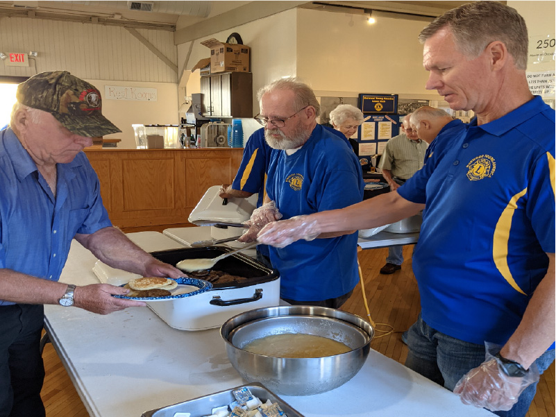 NYA Lions serving pancakes